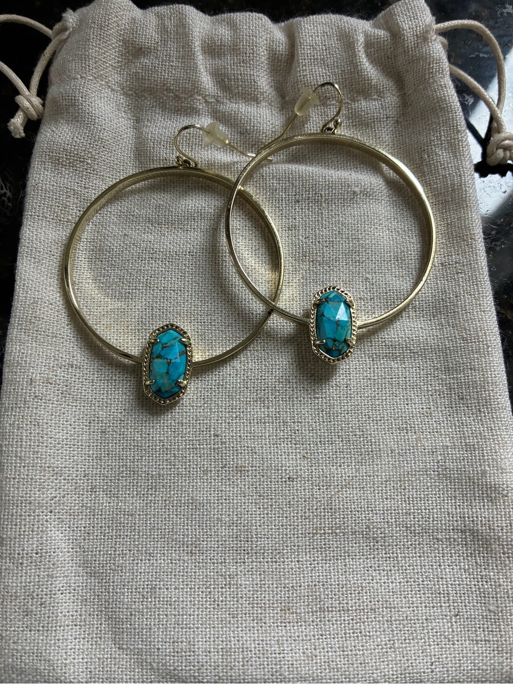 Kendra Scott gold Elora drop hoops in bronzed veined turquoise.